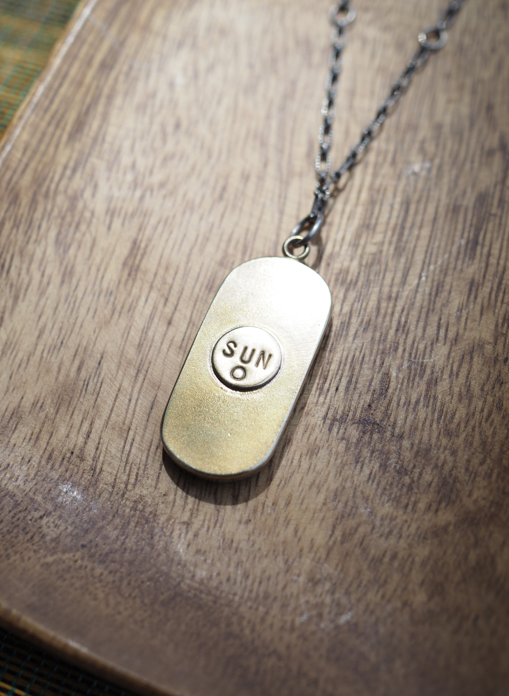 river stone + brass talisman