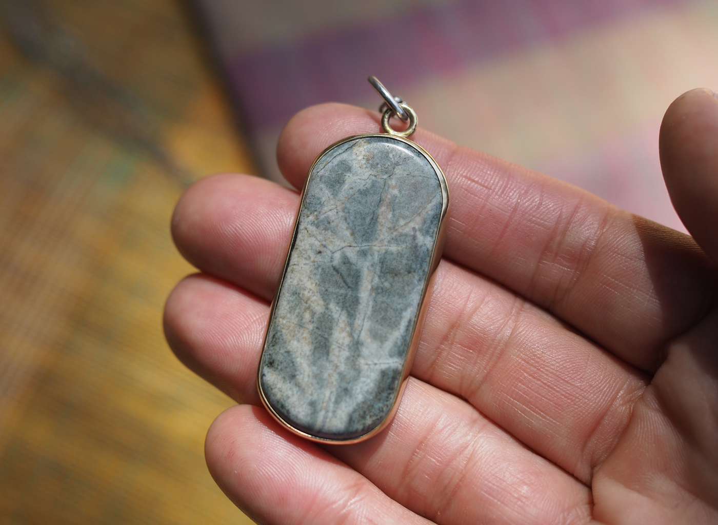 river stone + brass talisman